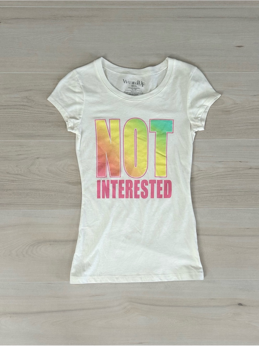 wound up “not interested” fitted baby tee